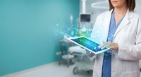 Female doctor using digital tablet with holographic medical interface in modern hospital room for telemedicine and healthcare technology applications.