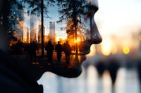 Double exposure profile silhouette blending with urban cityscape and forest at sunset, showing connection between nature and metropolitan life.