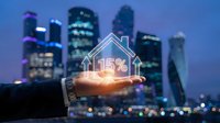 Business hand holding glowing house icon with 15% mortgage rate against city skyline at dusk for real estate investment concept.