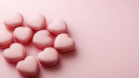 Heart shaped pink macarons arranged on pink background, sweet romantic dessert composition with delicate pastel colors and soft shadows for Valentine's day celebration.