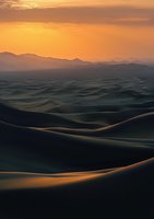 Dramatic desert landscape at sunset with rolling sand dunes casting long shadows against mountain silhouettes. Golden light illuminates curves creating mesmerizing patterns.