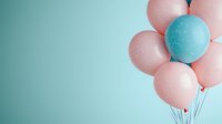 Festive bunch of pink and turquoise balloons floating against pastel blue background with copy space, modern minimalist party decoration concept.