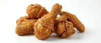 Crispy golden fried chicken nuggets and drumsticks isolated on white background, ready for food packaging, restaurant menus, and culinary design projects.