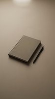 Minimalist beige notebook and black pen on neutral background for branding, stationery design, corporate identity, office supplies and business mockup.