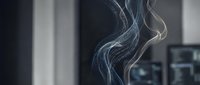 Elegant white smoke swirls rising gracefully against dark background in modern interior space creating atmospheric mood for relaxation concepts.
