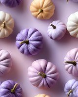 Colorful pastel pumpkins in purple, pink, and cream shades arranged on light purple background. Modern festive autumn composition for seasonal decor and social media.