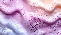 Luxurious foam texture with pink and purple gradient colors, bubbles and waves creating dreamy abstract background for cosmetic and skincare products.