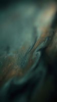 Macro close-up of weathered metal surface with rust and oxidation, shallow depth of field creating soft bokeh background, industrial texture detail.
