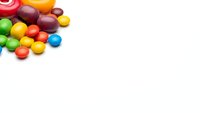 Colorful candy assortment scattered on white background with copy space for sweet treats and confectionery designs.