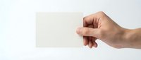 Hand holding blank white business card mockup on clean background for branding and corporate identity design projects.