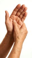 Mature adult male hands with age spots and wrinkles clapping together against white background. Suitable for healthcare, senior wellness, celebration, and appreciation concepts.