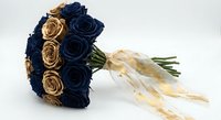 Navy blue and gold wedding bouquet with silk roses and cream ribbon on white background isolated for bridal design and event planning projects.