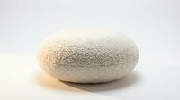 Round boucle fabric pouf ottoman in cream white, isolated on light background. Cozy textured floor cushion for modern minimalist interior design.