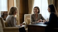 Three professional businesswomen having strategic meeting in elegant office setting with natural lighting and classic interior design elements.