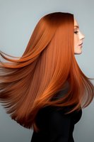 Woman with long, flowing copper-red hair in profile against neutral background. Straight, voluminous strands showcase healthy shine and vibrant color. Ideal for hair care, beauty, and salon marketing materials.