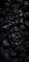 Black coal pieces with glowing golden cracks create dramatic contrast in dark moody lighting, forming abstract geological texture pattern for backgrounds.
