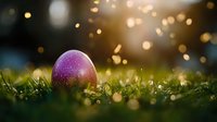 Purple glittery Easter egg nestled in fresh spring grass at sunset with magical golden bokeh lights creating dreamy holiday atmosphere.