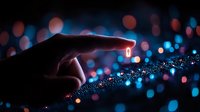 Glowing fingertip touching sparkly surface against blurred bokeh lights background creates magical atmosphere with red and blue illumination effects.