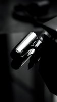 Luxury lipstick with metallic silver and black packaging displayed in monochrome, ideal for cosmetics, beauty, and makeup advertising campaigns.