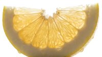 Sliced yellow lemon or citrus fruit segment isolated on white background, fresh produce for food and beverage design.