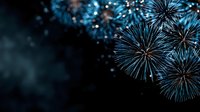 Spectacular blue and white fireworks exploding against dark night sky, creating festive atmosphere for celebration events and holiday backgrounds.