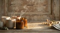 Lit candles in glass and ceramic containers with smoke wisps on rustic wooden surface, suitable for wellness, aromatherapy, and home decor designs.