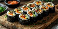 Fresh vegetable sushi rolls with carrots, cucumber and avocado served on rustic wooden board, garnished with sesame seeds and green onions. Asian cuisine.