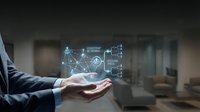 Businessman holding holographic digital network interface with data analytics and connectivity icons floating above palm in modern office environment.