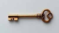 Vintage copper key with ornate decorative head isolated on white background for antique design projects and security concepts.