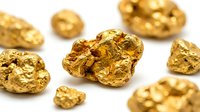 Raw gold nuggets scattered on white background showing natural metallic texture and irregular shapes for mining industry concepts.