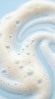 Creamy swirled foam texture with bubbles in soft pastel colors for spa wellness beauty skincare cosmetic product backgrounds and relaxation designs.