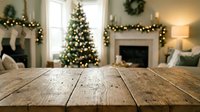 Rustic wooden table surface with blurred Christmas living room background featuring decorated tree, fireplace, and holiday lights for product display.