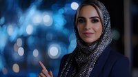 Professional Middle Eastern businesswoman in hijab smiling confidently against blue bokeh city lights background for corporate and diversity concepts.