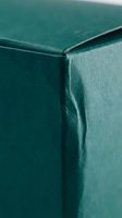 Teal green leather upholstery corner detail showing rich texture and craftsmanship of luxury furniture piece for interior design and home decor projects.