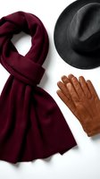 Stylish winter accessories set with burgundy wool scarf, charcoal felt hat and brown leather gloves on white background for fashion and seasonal wear.