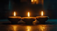 Three oil lamps with burning flames on dark surface, creating warm golden light and peaceful ambiance for meditation, spirituality, and relaxation themes.