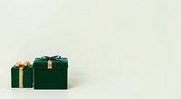 Wrapped green gift boxes with gold ribbons and bows arranged on neutral background, suitable for holiday, Christmas, birthday, and celebration marketing materials.