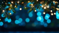 Magical bokeh lights with green leaves create dreamy night atmosphere. Glowing string lights and blurred circles form enchanting backdrop for festive occasions.