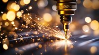 Macro shot of CNC machine drilling metal with bright orange sparks flying against dark background with bokeh lights, showcasing industrial precision manufacturing.