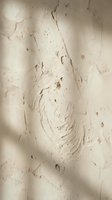Weathered plaster wall with peeling paint and cracks showing aged texture and decay. Vintage grunge surface with natural wear patterns for interior design projects.