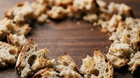 Whole grain cereal pieces arranged in circle on wooden surface, close-up food photography for breakfast and nutrition content.