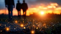 Silhouettes of people walking at sunset with magical glowing fireflies or light particles in foreground creating dreamy atmospheric scene. Nature photography.
