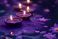 Purple diwali clay lamps lit on textured surface with floating flower petals and bokeh lights creating mystical spiritual ambiance for meditation and wellness.