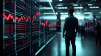 Silhouette of businessman looking at glowing red financial market data and charts on digital display wall in dark modern trading room with blue lighting.