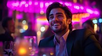Young Hispanic man in business attire smiling at nightclub with vibrant purple neon lights, bokeh background and wine glass on table, expressing joy and confidence.