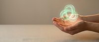 Hands holding glowing green circular energy rings with magical light effects for technology and innovation concepts in business presentations.