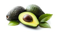 Fresh ripe avocados with green leaves, one cut in half showing brown pit on white background, isolated healthy organic food for cooking and nutrition.