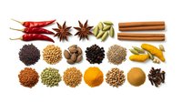 Colorful collection of aromatic spices and herbs arranged on white background for culinary cooking and seasoning recipes.