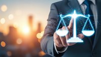 Businessman touching glowing digital justice scales hologram with city bokeh background. Legal technology concept for law firms and judicial services.