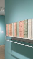 Modern library interior with vintage books on floating shelf against turquoise wall in contemporary reading space for education and literature concepts.